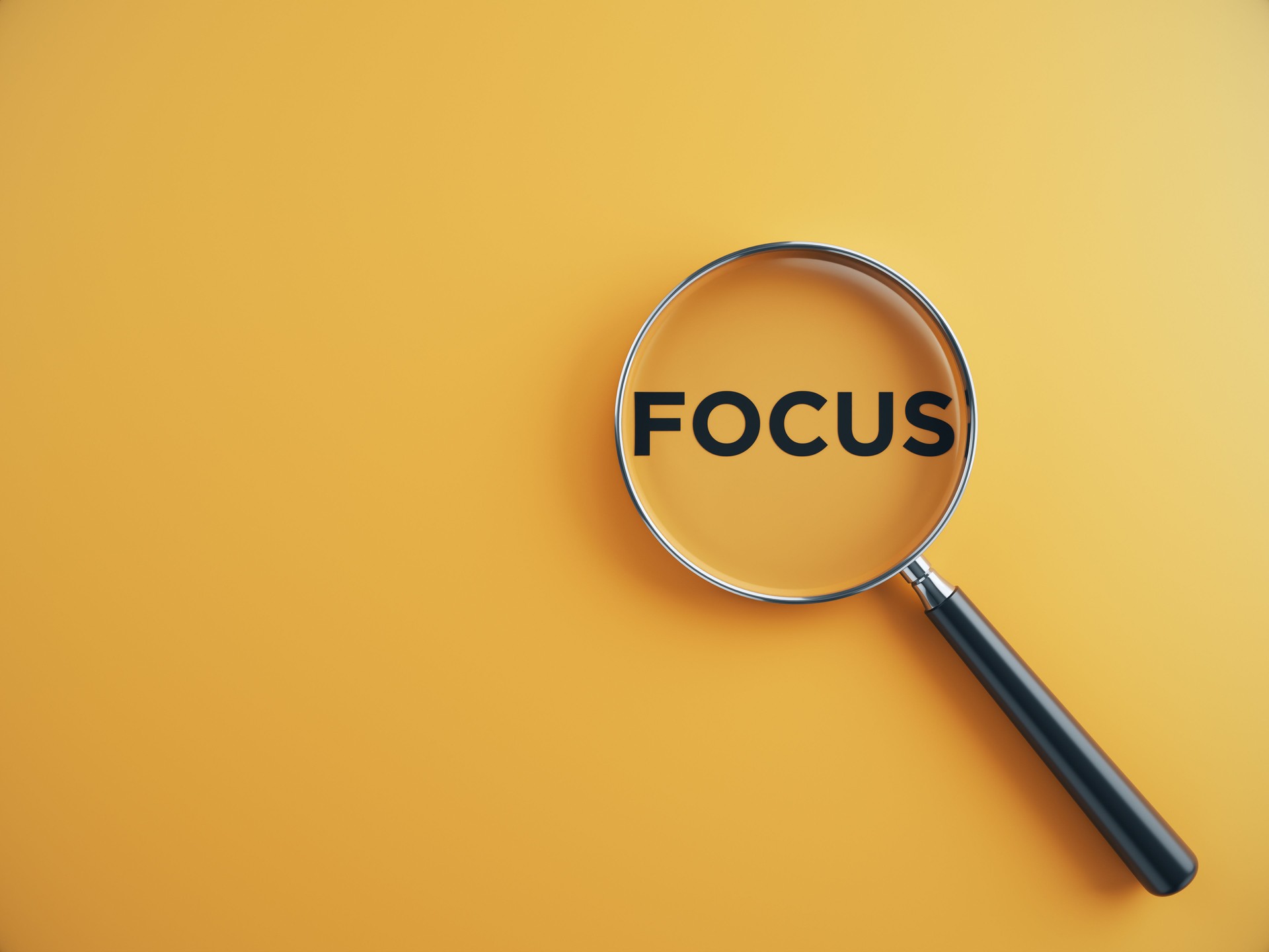 Focus wording inside of Magnifying glass on an orange background
